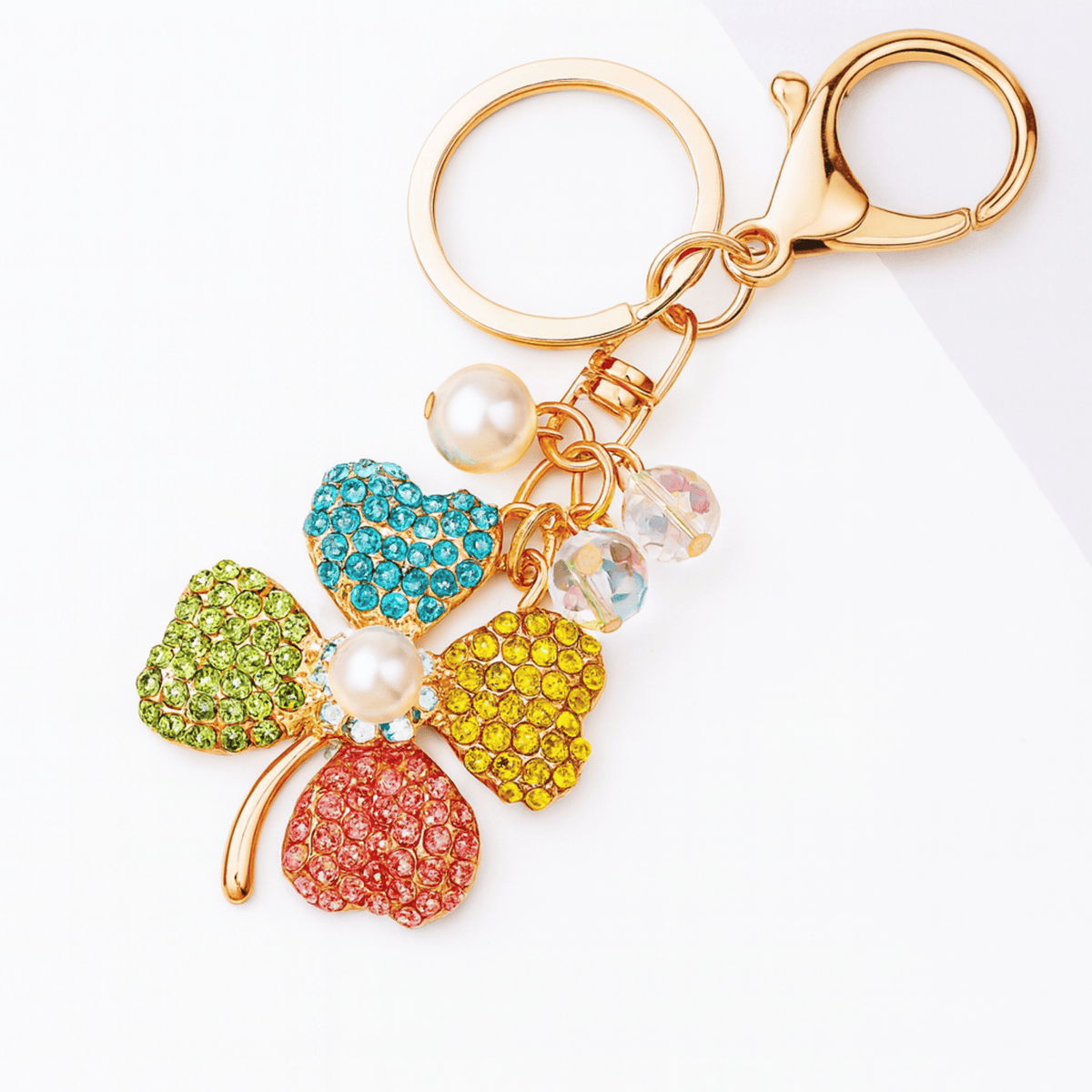 Colorful keychain with floral design and gold clasp on a white background